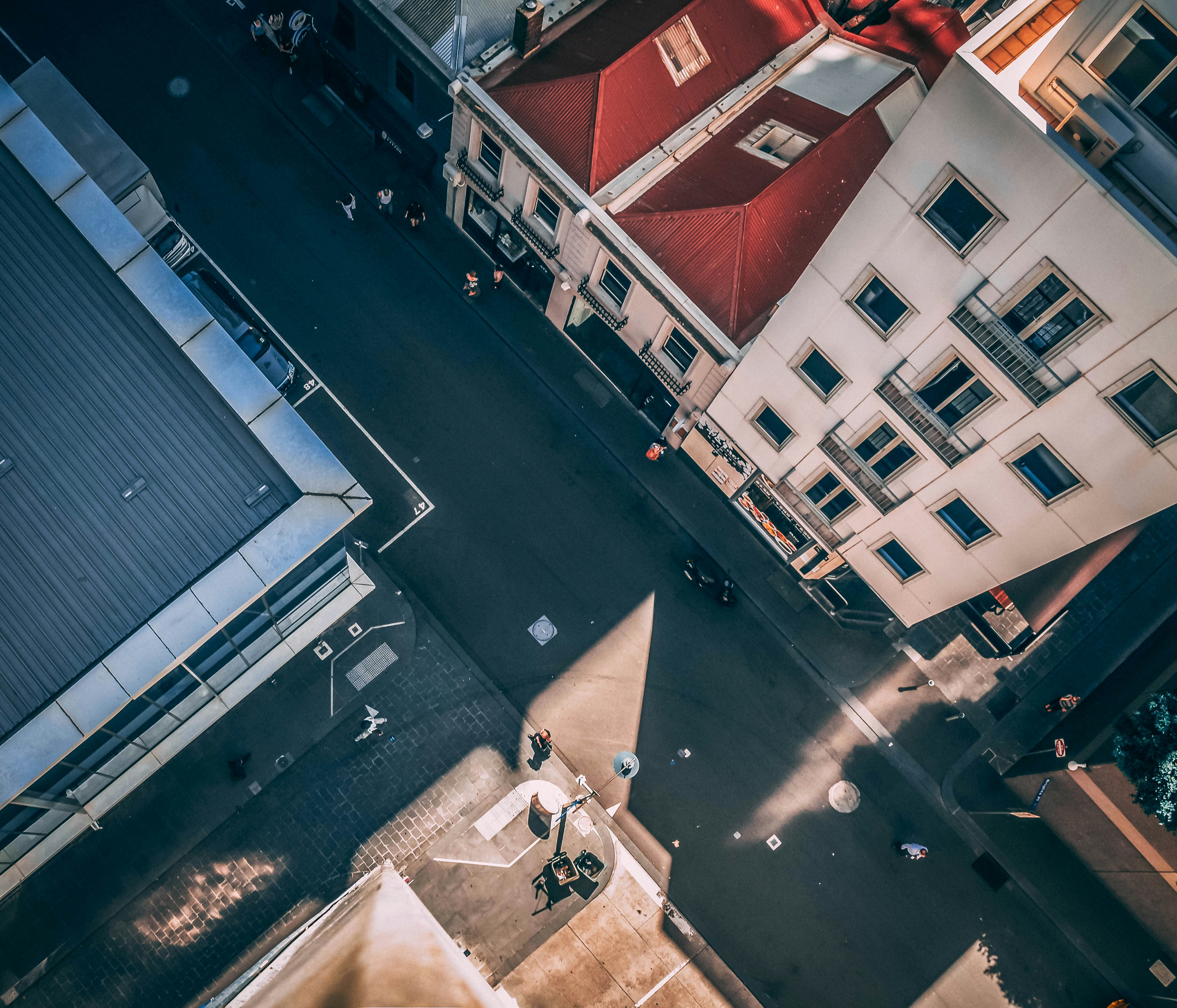 aerial photography of asphalt road between buildings